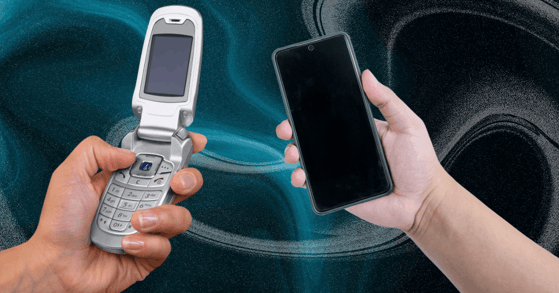 One hand holds a flip phone, while another holds a smartphone.