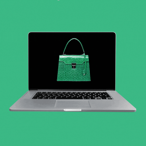 A laptop with a green purse on the screen and a white cursor blinking over it.