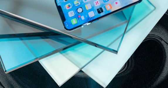 A stack of blue glass with an iPhone on top.