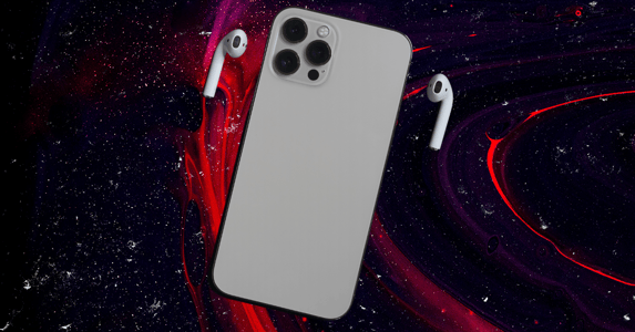 An iPhone face down and AirPods on a red and black background.