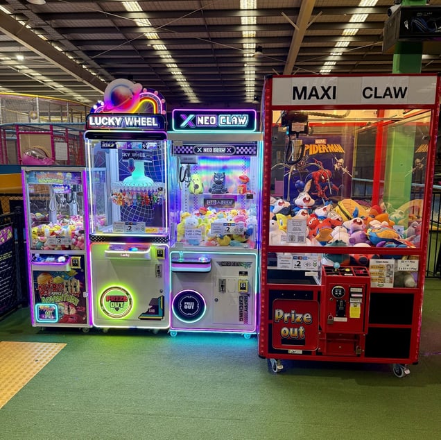 Operator's Machines: Four modern, glowing claw machines—including "LUCKY WHEEL" and "NEO CLAW"—owned by operator Jack Ennis.