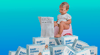 Toddler in glasses sits on pink potty reading newspaper, surrounded by stacks of baby diaper boxes