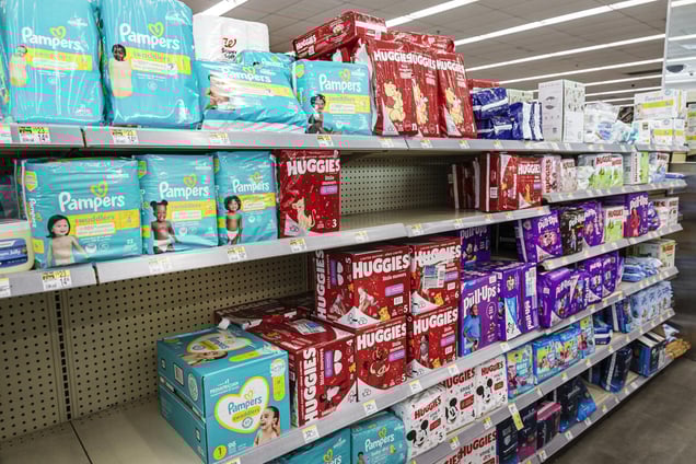 Walgreens diaper aisle stocked with Pampers and Huggies brands in various sizes and styles