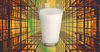 A glass of milk on a yellow geometric background.