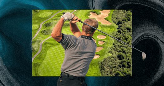 A blonde man shown from behind swinging a golf club with a golf course in the background.