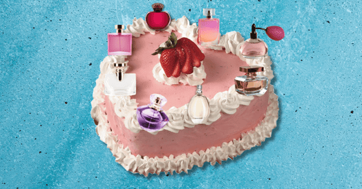 A heart-shaped cake with perfume bottles on the icing. 