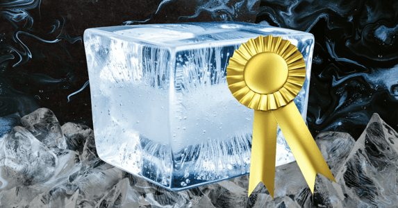 A block of ice with a gold ribbon on it. 