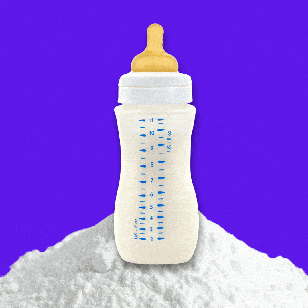 A baby's bottle shaking on a mound of white powder. 