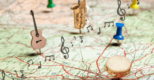 A map with several musical instrument pins stuck into it, including a drum, saxophone, and guitar.
