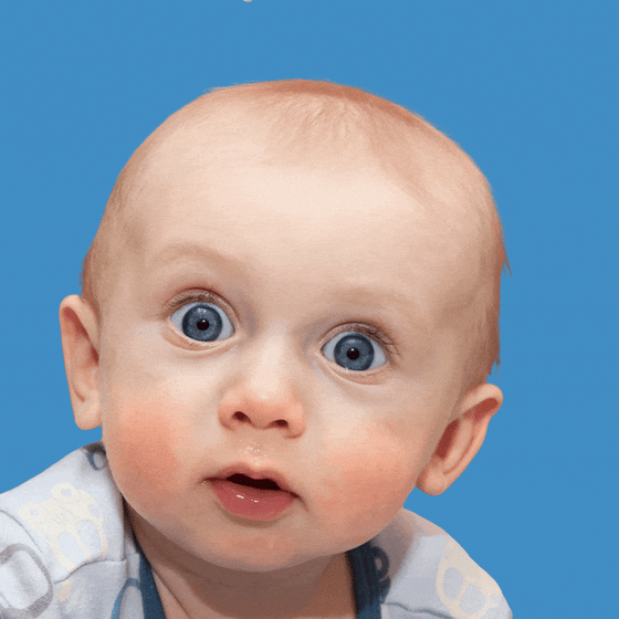 A white baby with blue eyes blinking.