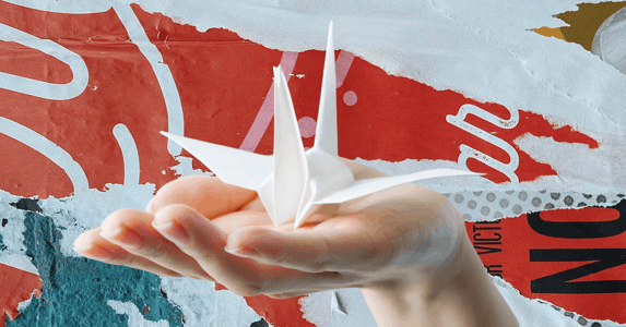 A hand holding a paper crane.