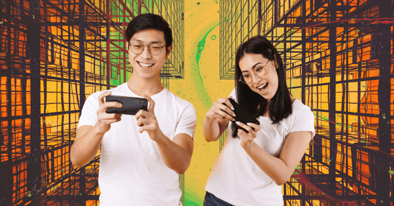 A man and a woman play games on their phones.