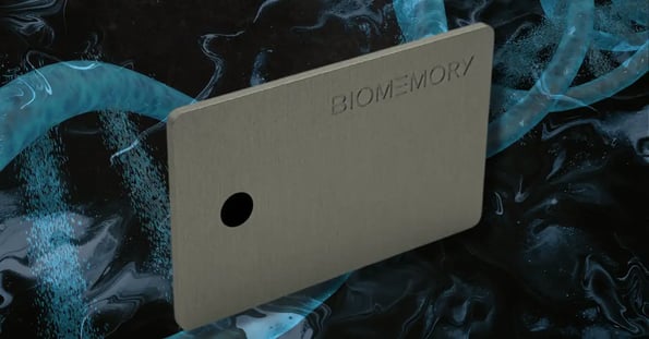 A silver Biomemory card on a blue and black background with a DNA strand.