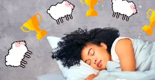 A Black woman wearing a white T-shirt and sleeping on a bed with a pillow and white sheets.