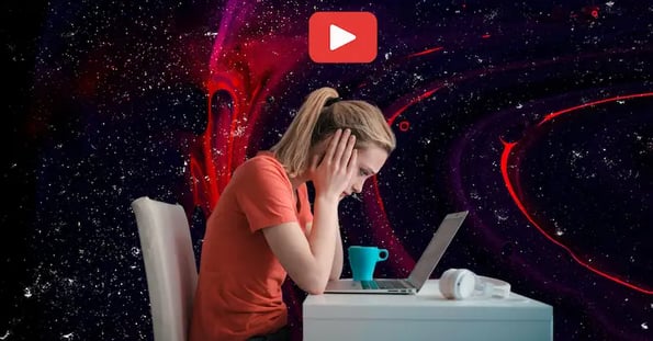A white woman with blonde hair sits sadly in front of her laptop. Overhead is a red play button.