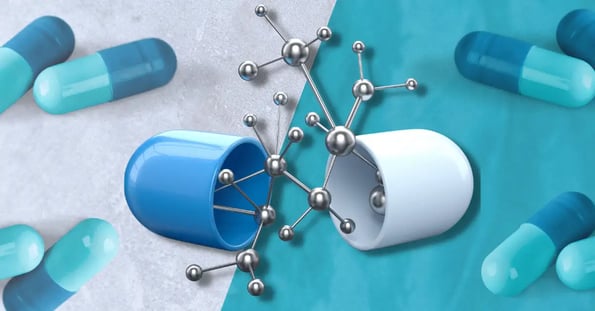 A blue and white capsule split open with a silver molecule emerging from the middle and a bunch of blue pills in the background.