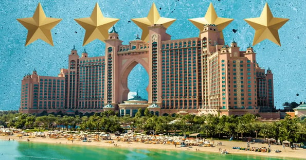The Atlantis hotel on a blue background with five gold stars.