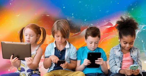 Four children sitting in a row staring at iPads, phones, and tablets.