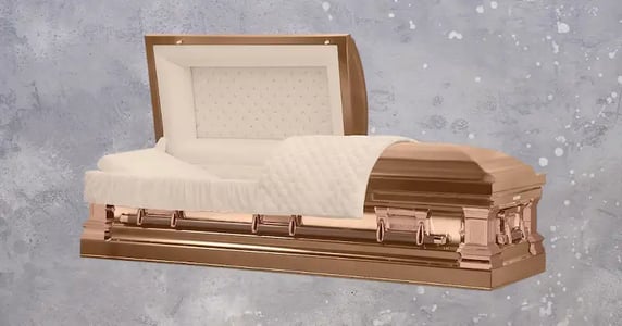 A copper-colored casket with a white lining on a gray background.