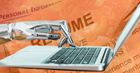 A silver robot hand typing on a laptop on an orange background with a transparent photo of a resume and a job application.