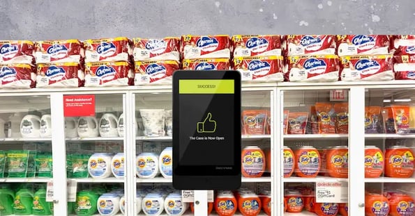 A locked Target case full of laundry detergents. In front is a phone screen displaying a notification that the case is now unlocked.