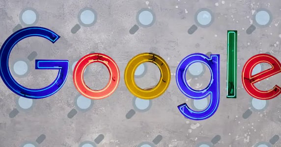 The Google wordmark against a gray background patterned with magnifying glass icons.
