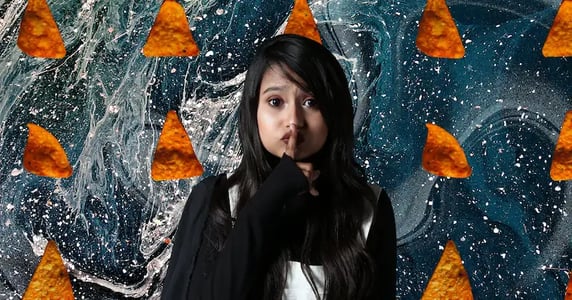 A woman making the “shh” gesture in front of rows of Doritos chips on a blue background with white swirls.
