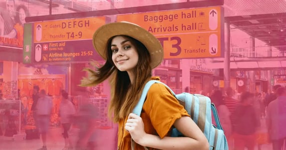 A white woman with brown hair smiling and wearing a sunhat and a light-blue backpack; a photo of a busy airport faded in the background.