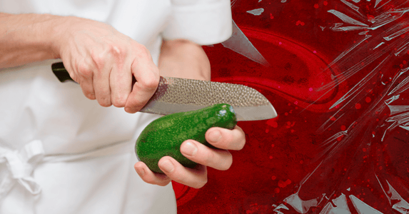 A close-up of someone cutting open an avocado.