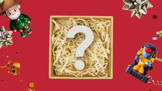 A box full of straw and a question mark surrounded by toys.