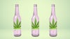 Three glasses bottles, each with a cannabis leaf on it.