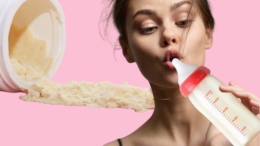 A young woman drinks from a baby bottle. Behind her is a tipped over jar of colostrum powder.