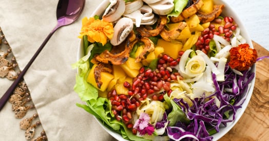 A bowl full of fruits and veggies.