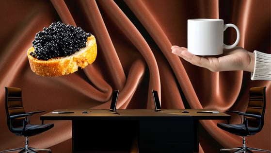 A desk and two chairs sit in front of a brown curtain. On one sized, an oversized hand holds out a white coffee mug. On the other is an oversized piece of bread topped with caviar.