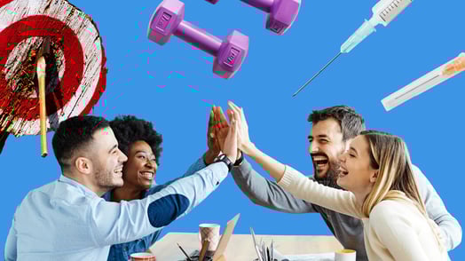A group of laughing people high-five over a table. Around them are hand weights, syringes, and a target with an axe in it.