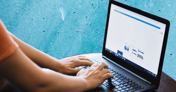 Person typing on a laptop. 