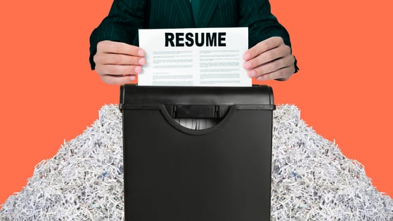 A person shredding a paper resume. 