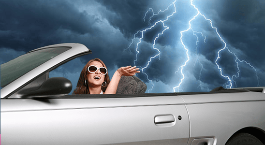 woman driving convertible mustang in the rain