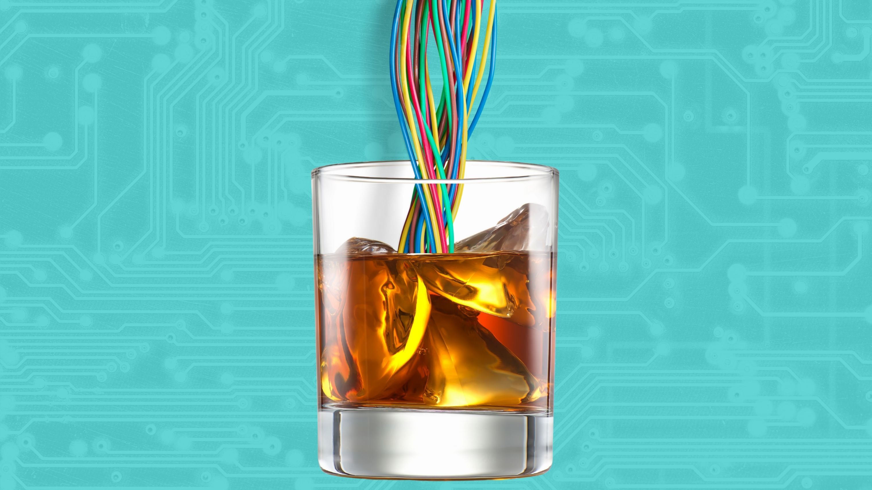 A cup of whiskey with wires being poured into it