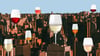 Several glasses of wine imposed over a cityscape.